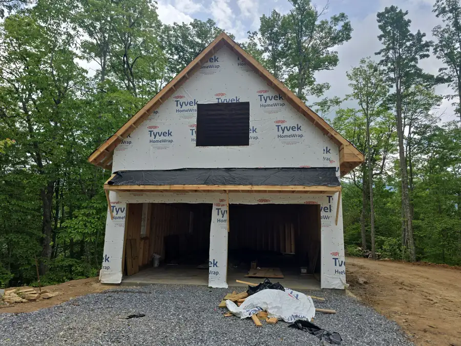 Detached garage framed and wrapped, partway through construction