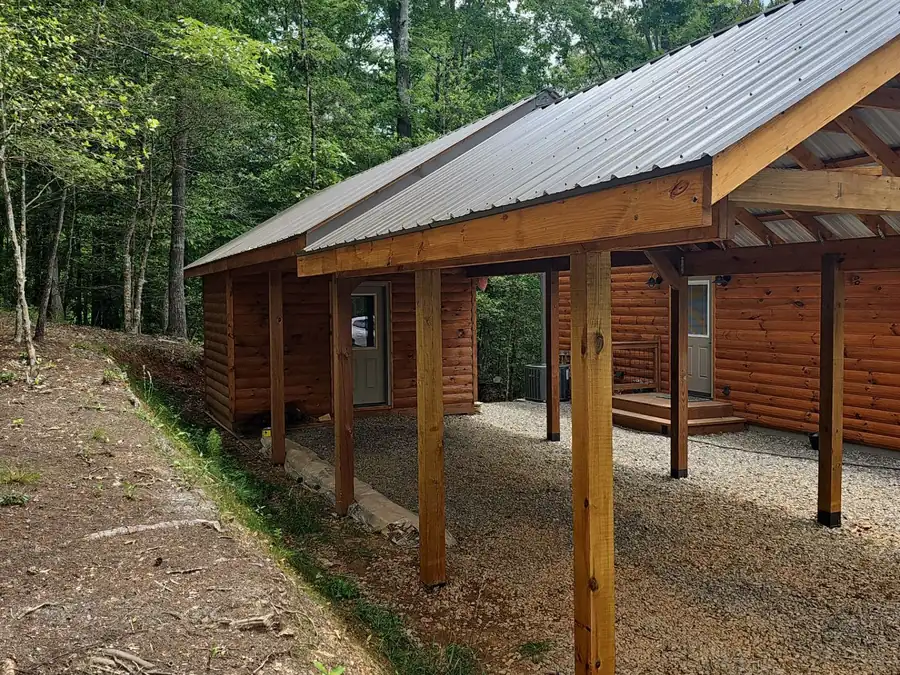 Covered breezeway with a standing seam metal roof on a log home