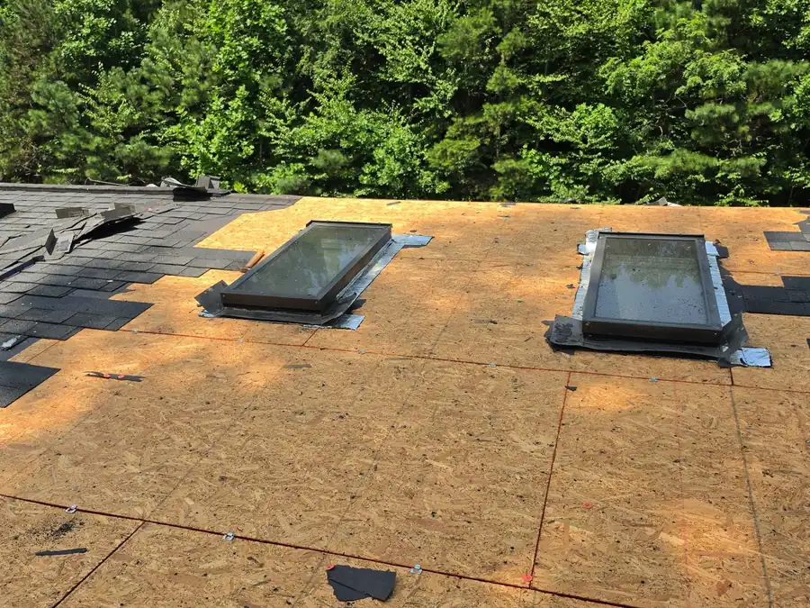 Fresh decking, underlayment and two newly set skylights partway through a re-roof