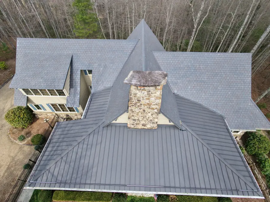 Standing seam metal roof and stone chimney on a mountain home near Highlands, NC