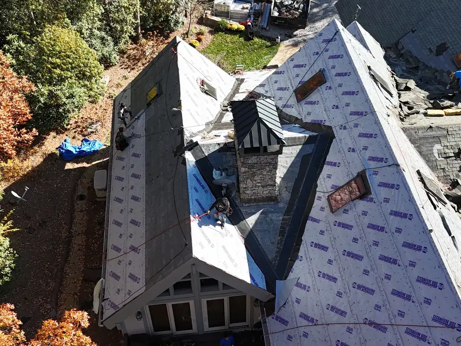Synthetic underlayment rolled over fresh decking partway through a re-roof